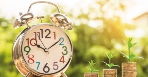 reloj con monedas según la hora del día para reflejar la tarifa regulada luz